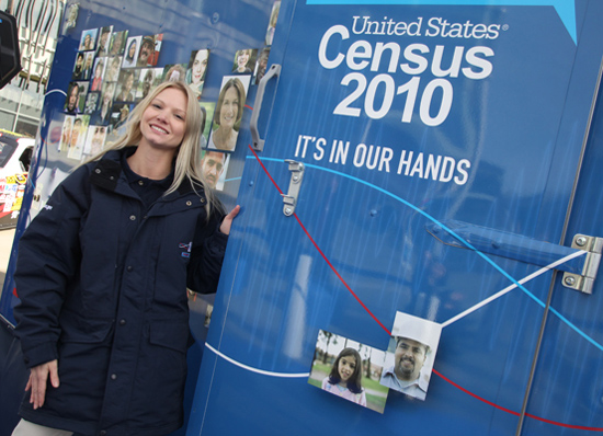 A Census road tour staff member helps set up a stand at an event in Suitland, Md. - Photo: Census Bureau.