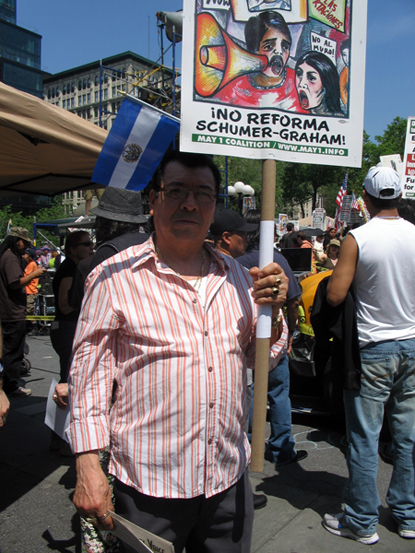 Man Holding Sign Criticizing Immigration Reform Blueprint of Senator Schumer - Photo: Cristina DC Pastor