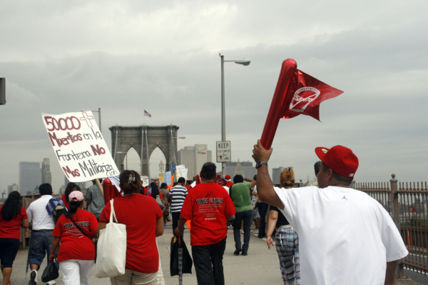 Immigrants and their supporters march across the Brooklyn Bridge on July 29, 2010 - Photo: Sarah Kramer
