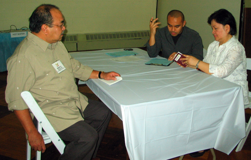 Attorney Merit Salud (left) assisting a Filipino woman who has questions about immigration - Photo: Cristina DC Pastor