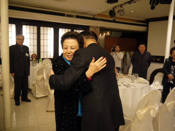 John Liu gets a hug from a longtime supporter at a recent fundraiser