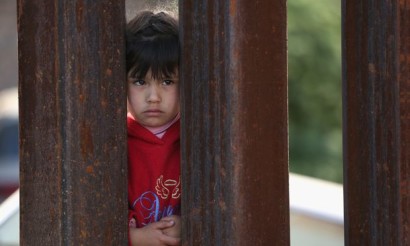 A child on the Mexican side of the U.S.-Mexico border fence. (Photo: WNYC)