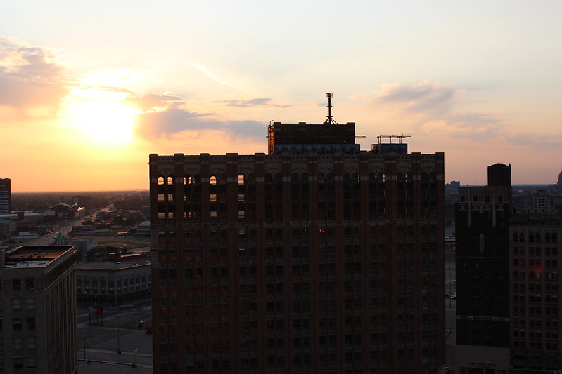 A building in shadow in Detroit, with the sun behind it.